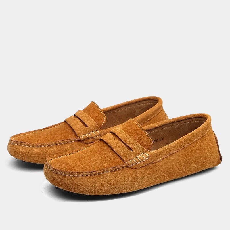Rust orange suede penny loafers with contrast stitching and flexible sole
