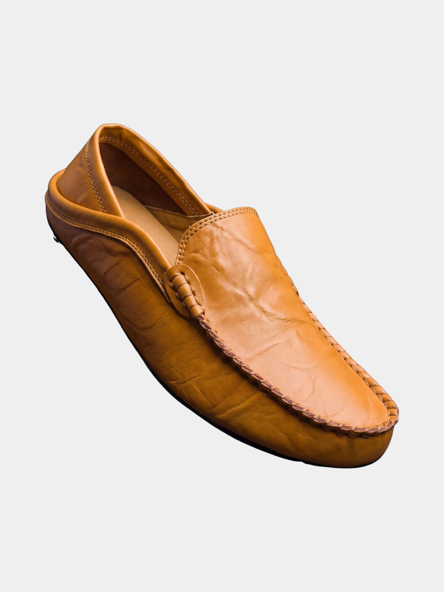 Tan leather slip-on moccasins with contrast stitched apron and buckle detail