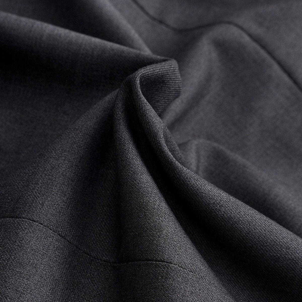 Close-up of charcoal blazer fabric showing woven texture and drape