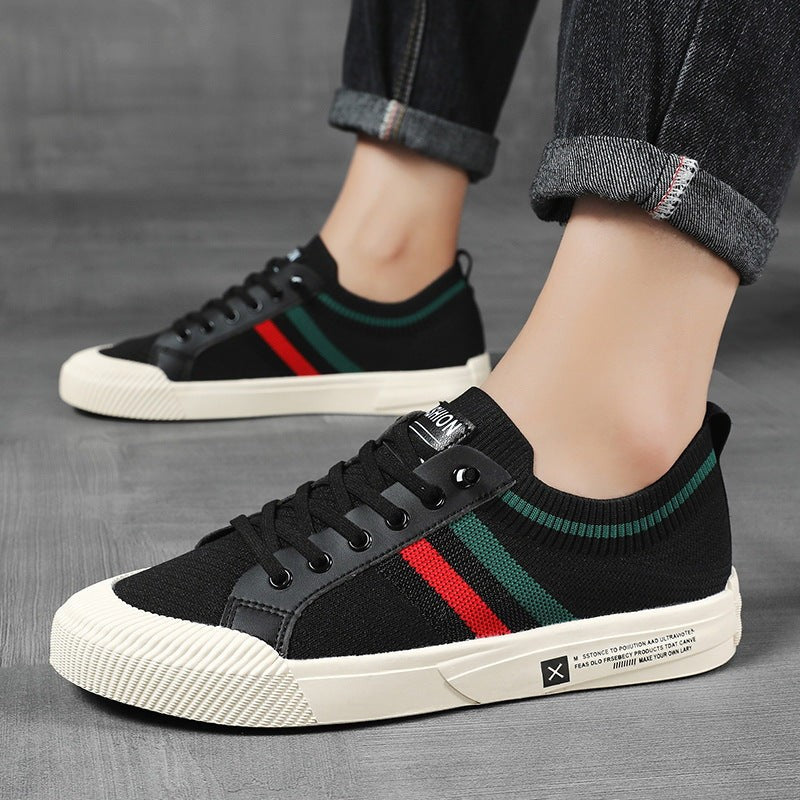 Black mesh trainer worn with jeans, showing ribbed rubber sole