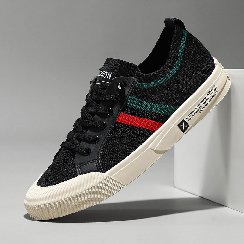 Black knit trainer with contrasting red and green stripe accent