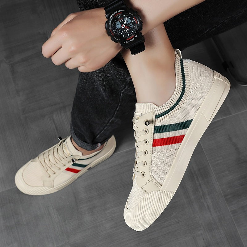 Beige knitted sneaker worn on foot, styled with a wristwatch