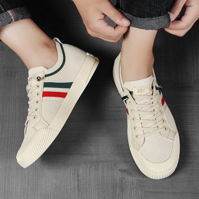 Close-up of cream mesh trainers being laced up by hand