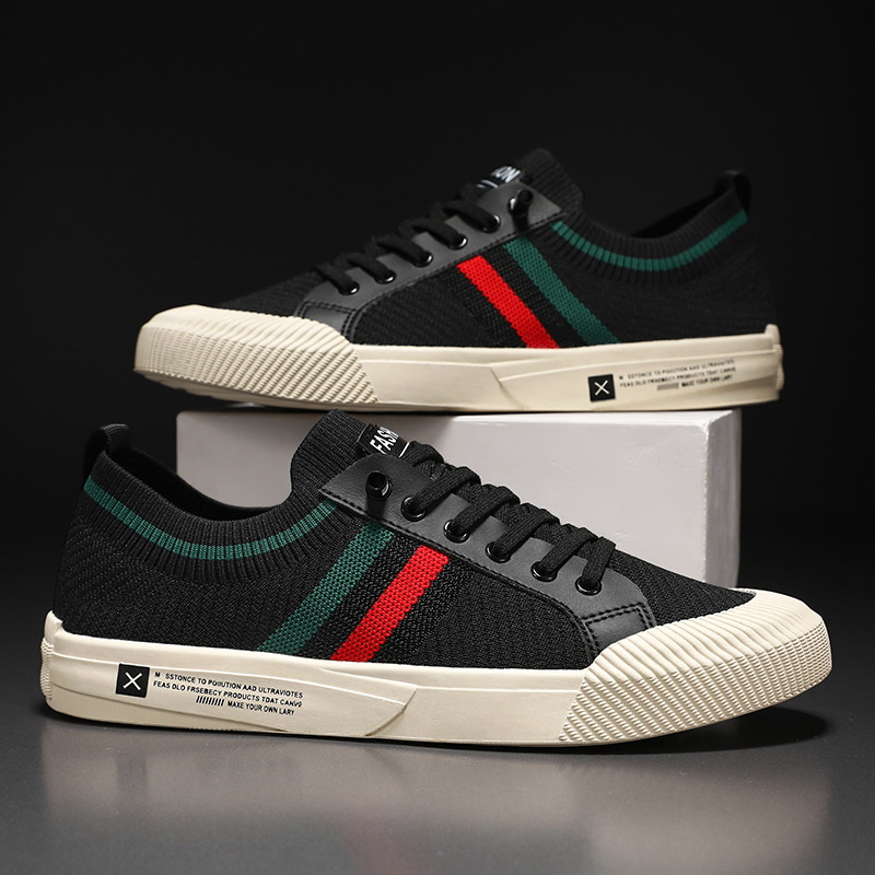 Pair of black lace-up sneakers with green and red stripe design