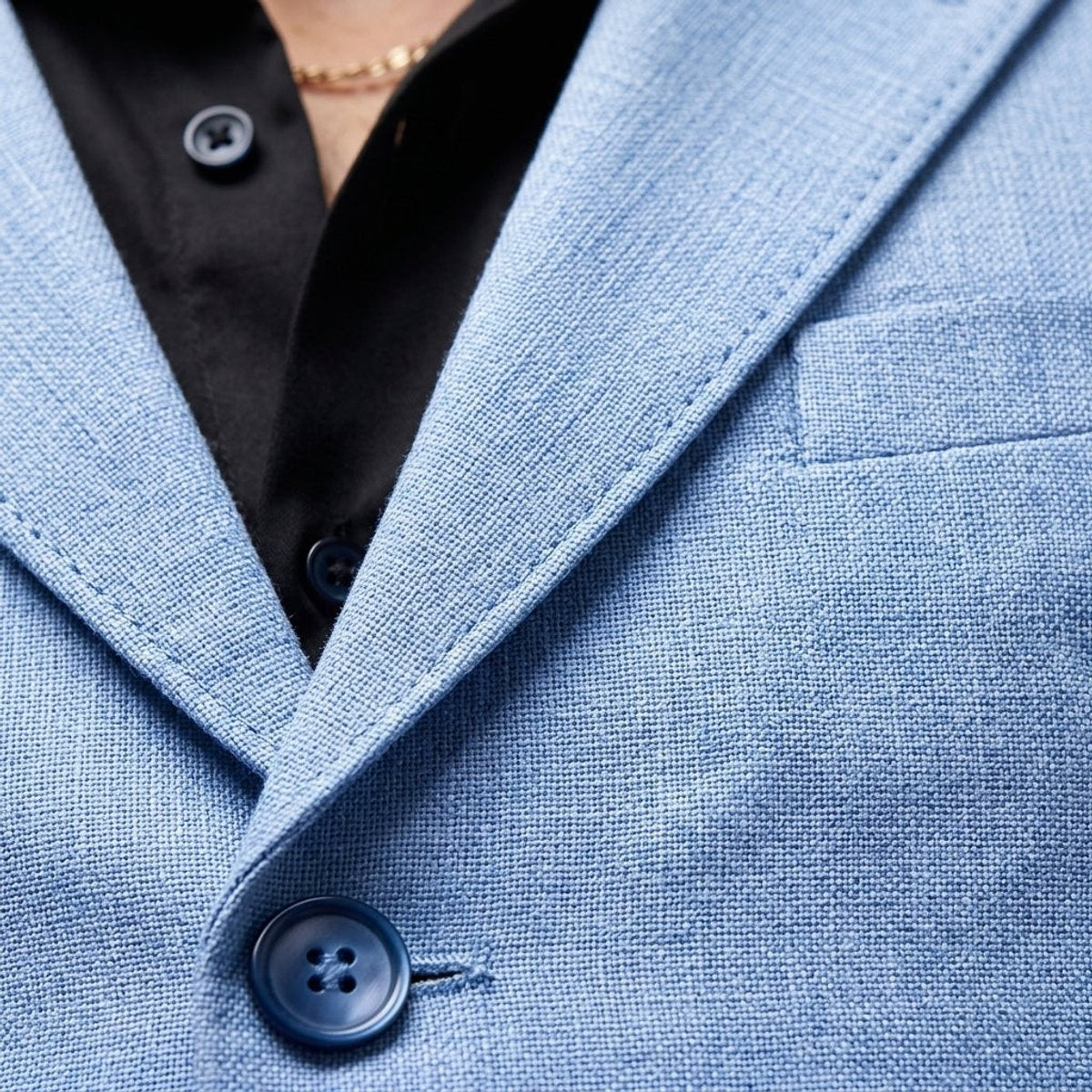 Close-up of pale blue linen blend blazer showing textured weave and buttons