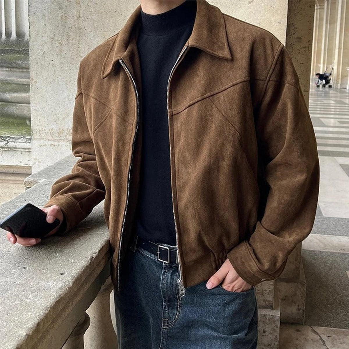 Man wearing brown suede zip-up bomber jacket with pointed collar outdoors