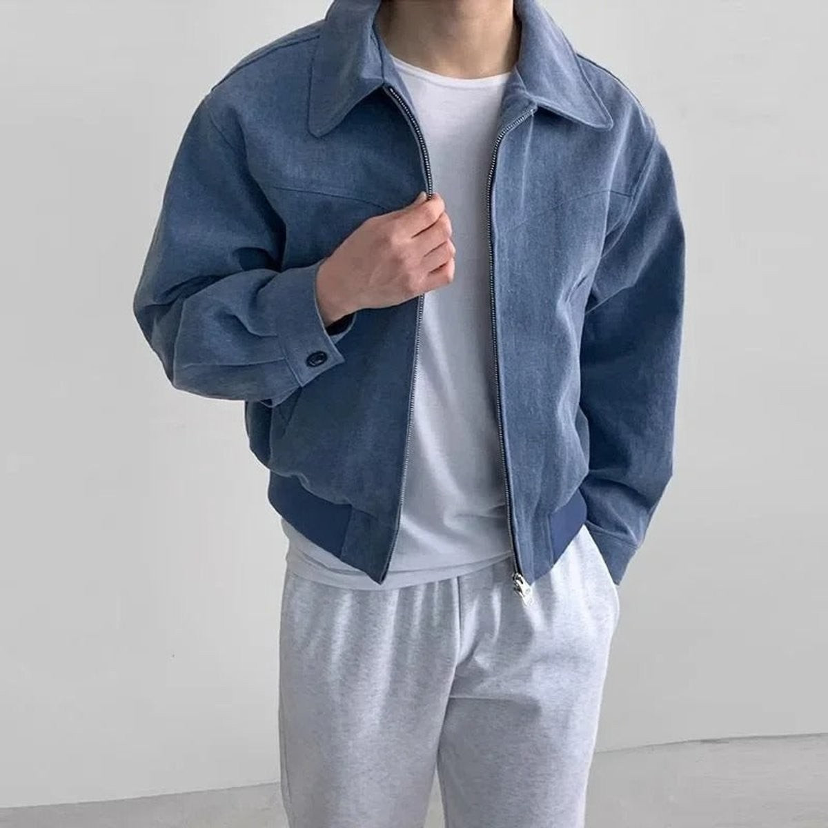 Blue suede bomber jacket worn open over plain white t-shirt