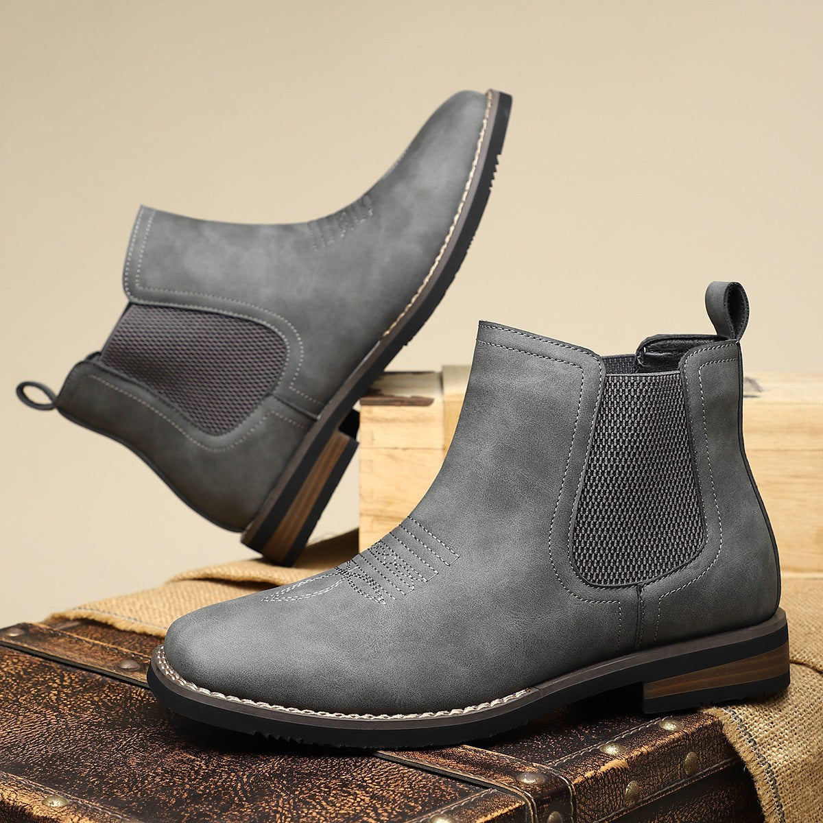 Grey suede-effect Chelsea boots shown from side and sole angle