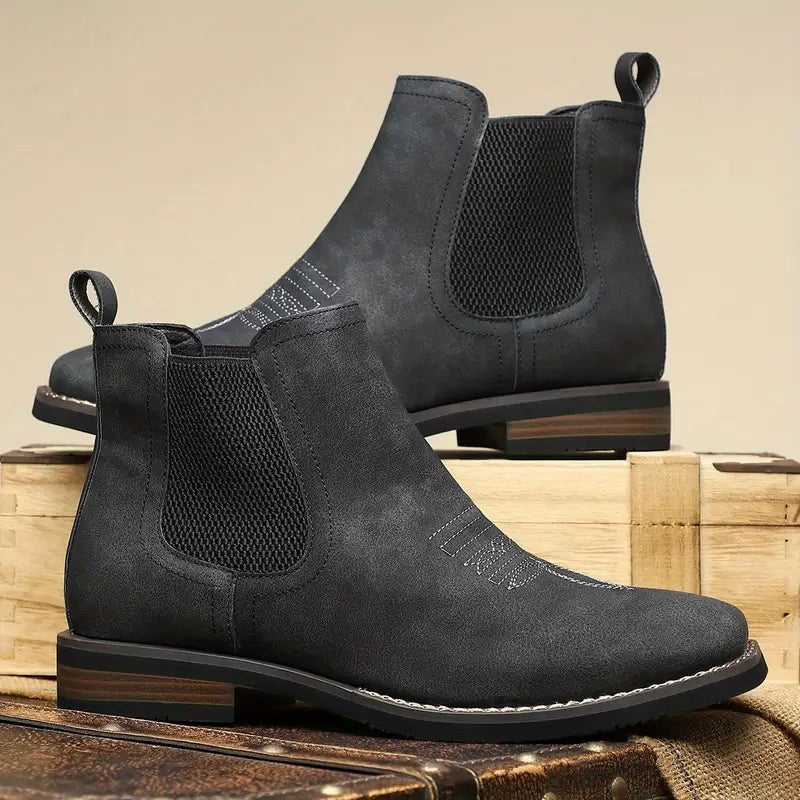 Black leather Chelsea boots with stitched western-style toe detail
