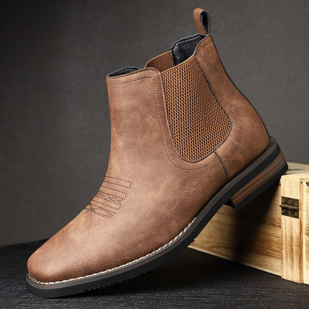 Brown leather Chelsea boot featuring western-style stitching and pull tab