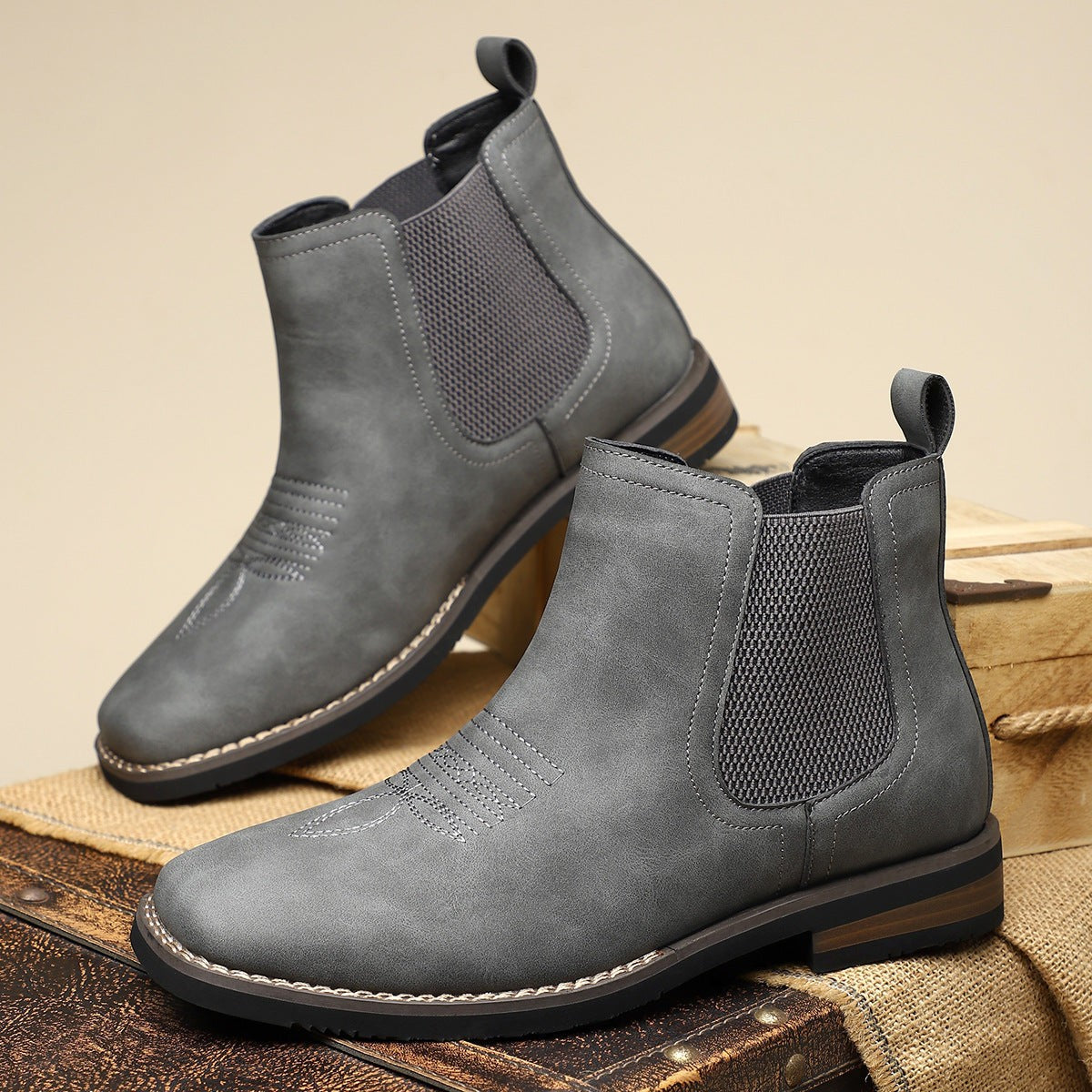 Pair of grey leather Chelsea boots with stitched western detailing