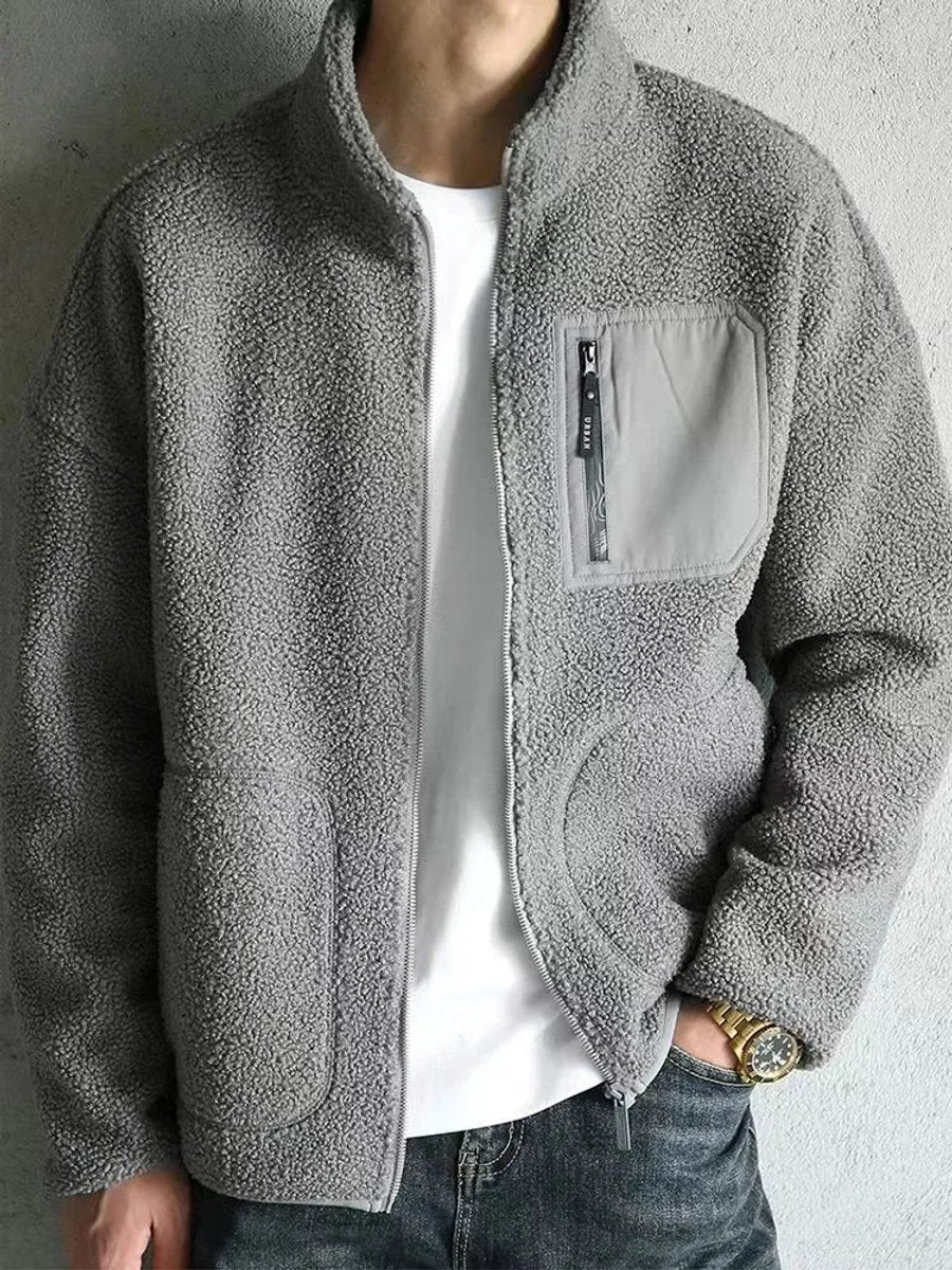 Grey sherpa fleece jacket with zip chest pocket, styled with jeans