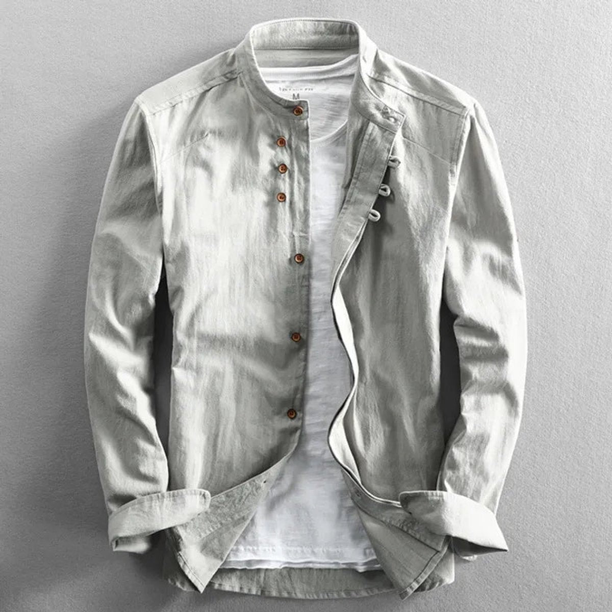 Stone-coloured Henley linen shirt with stand collar, layered over white T-shirt
