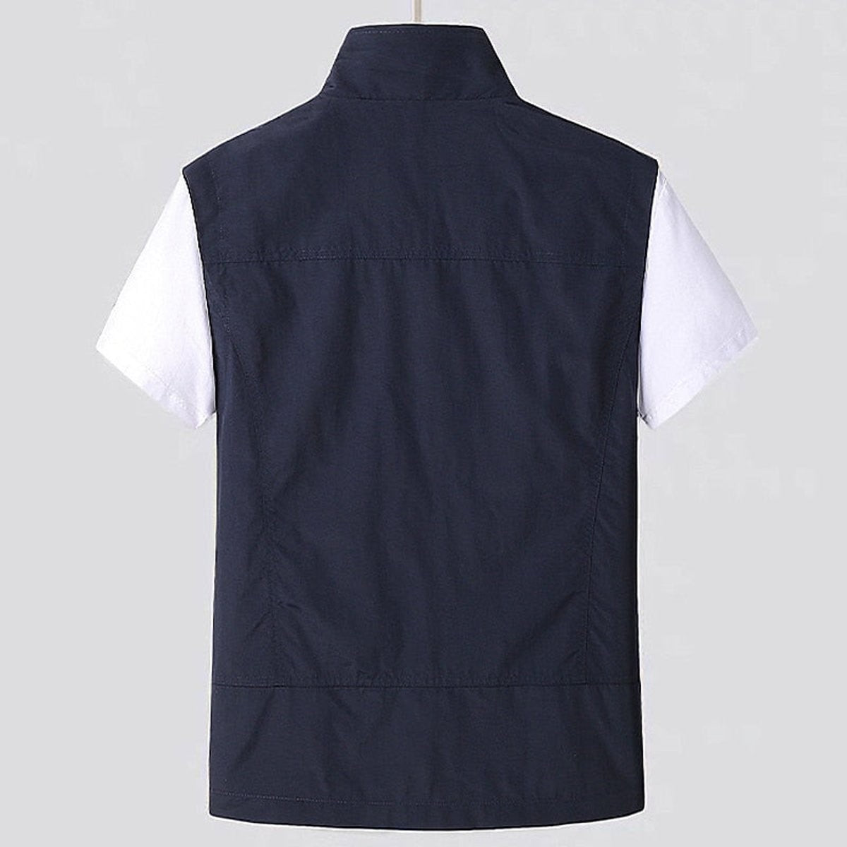 Rear view of navy sleeveless utility vest showing plain back panelling