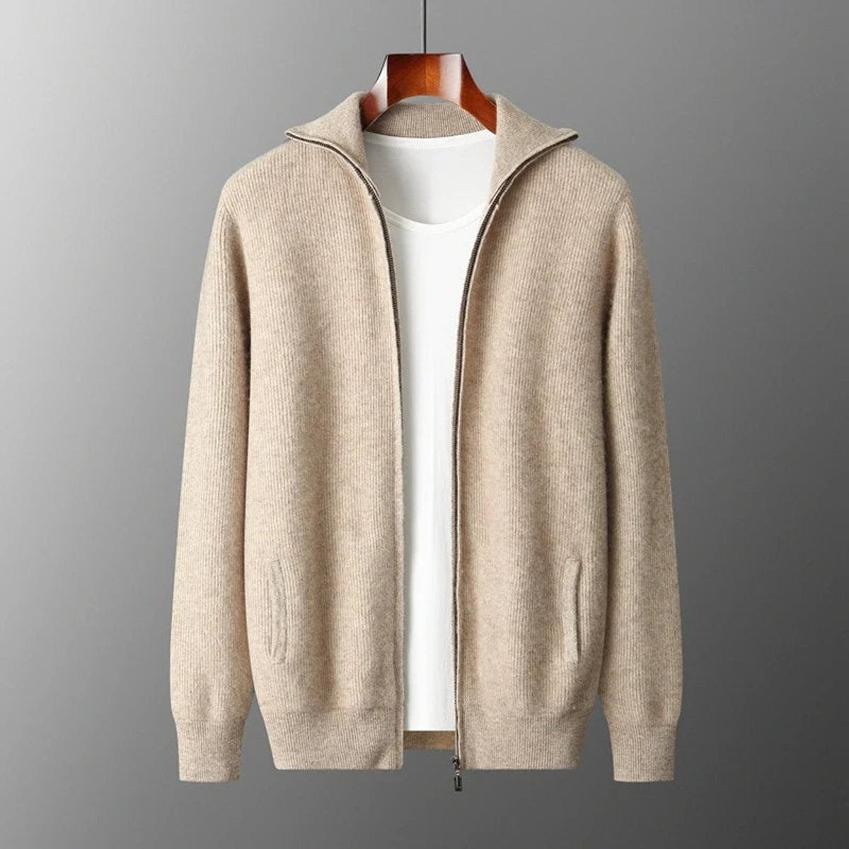 Beige ribbed cashmere zip cardigan with stand collar, shown on hanger