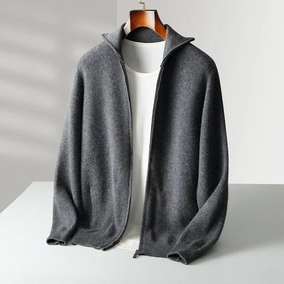 Charcoal grey ribbed knit zip cardigan with stand collar, hanging
