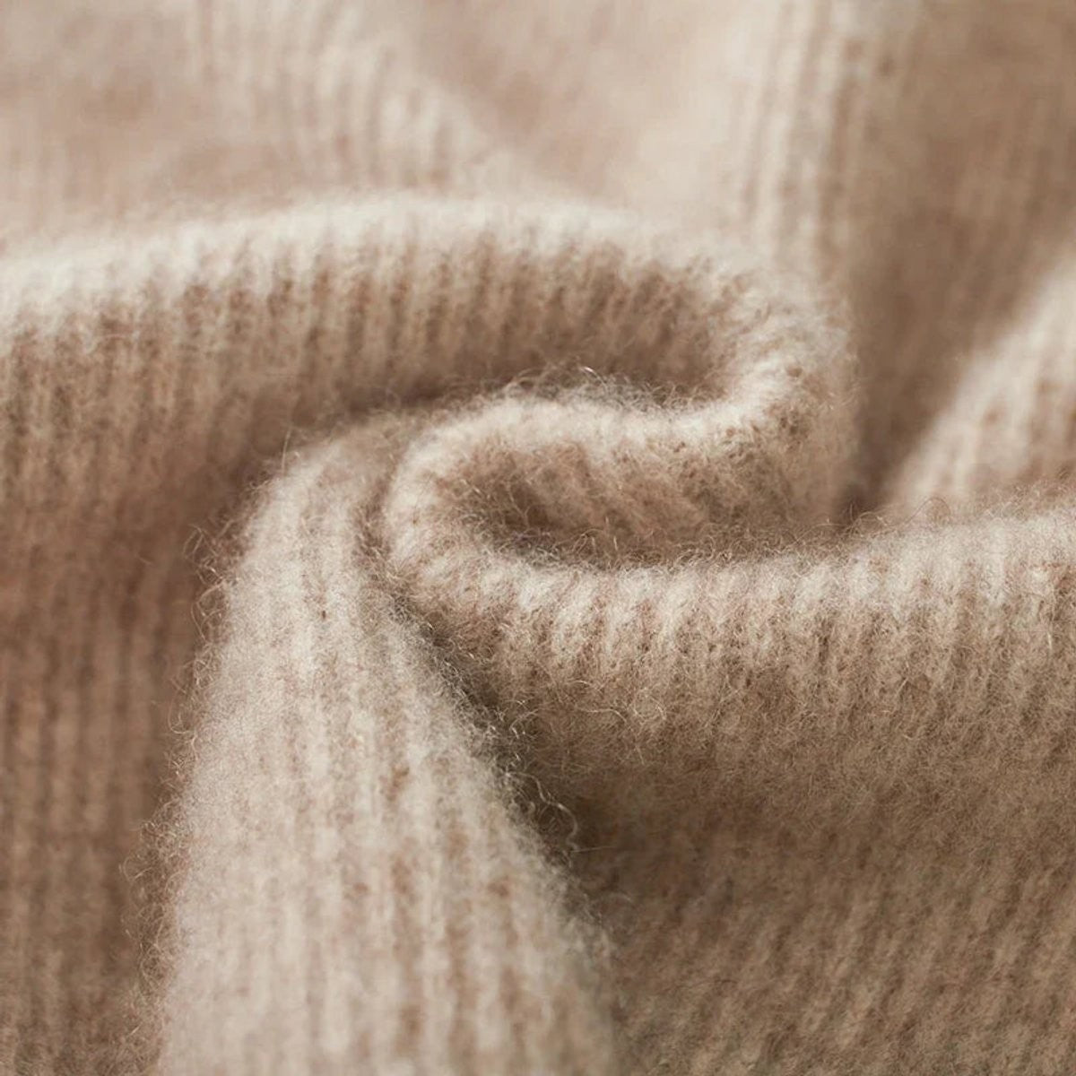 Close-up of beige ribbed cashmere knit fabric texture, soft finish