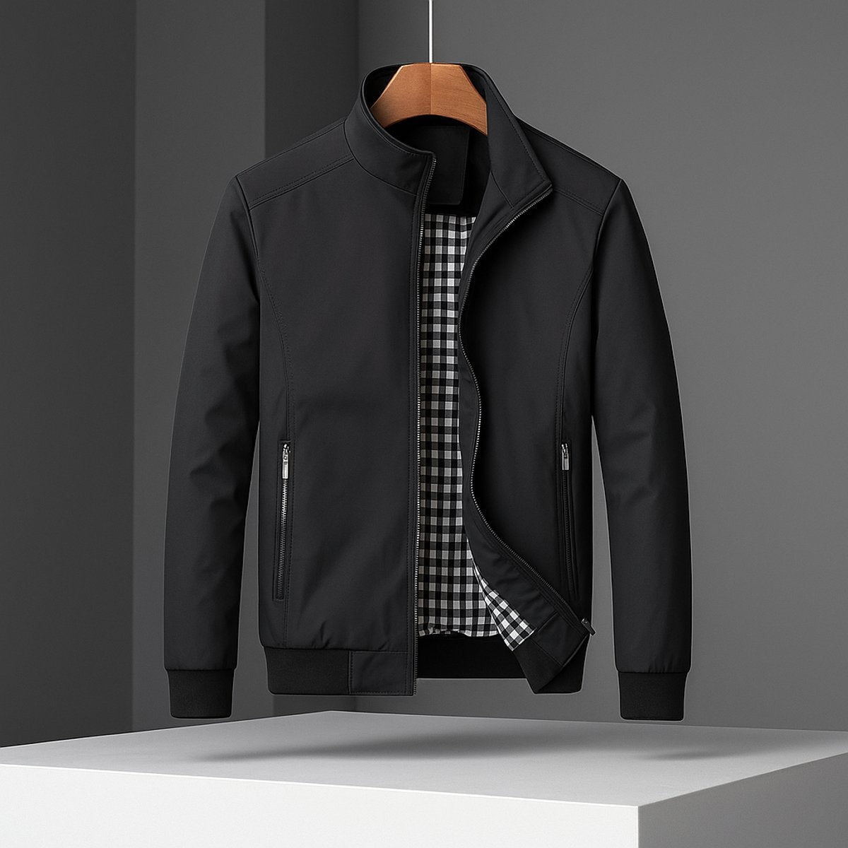 Black waterproof bomber jacket with zip pockets and checked inner lining