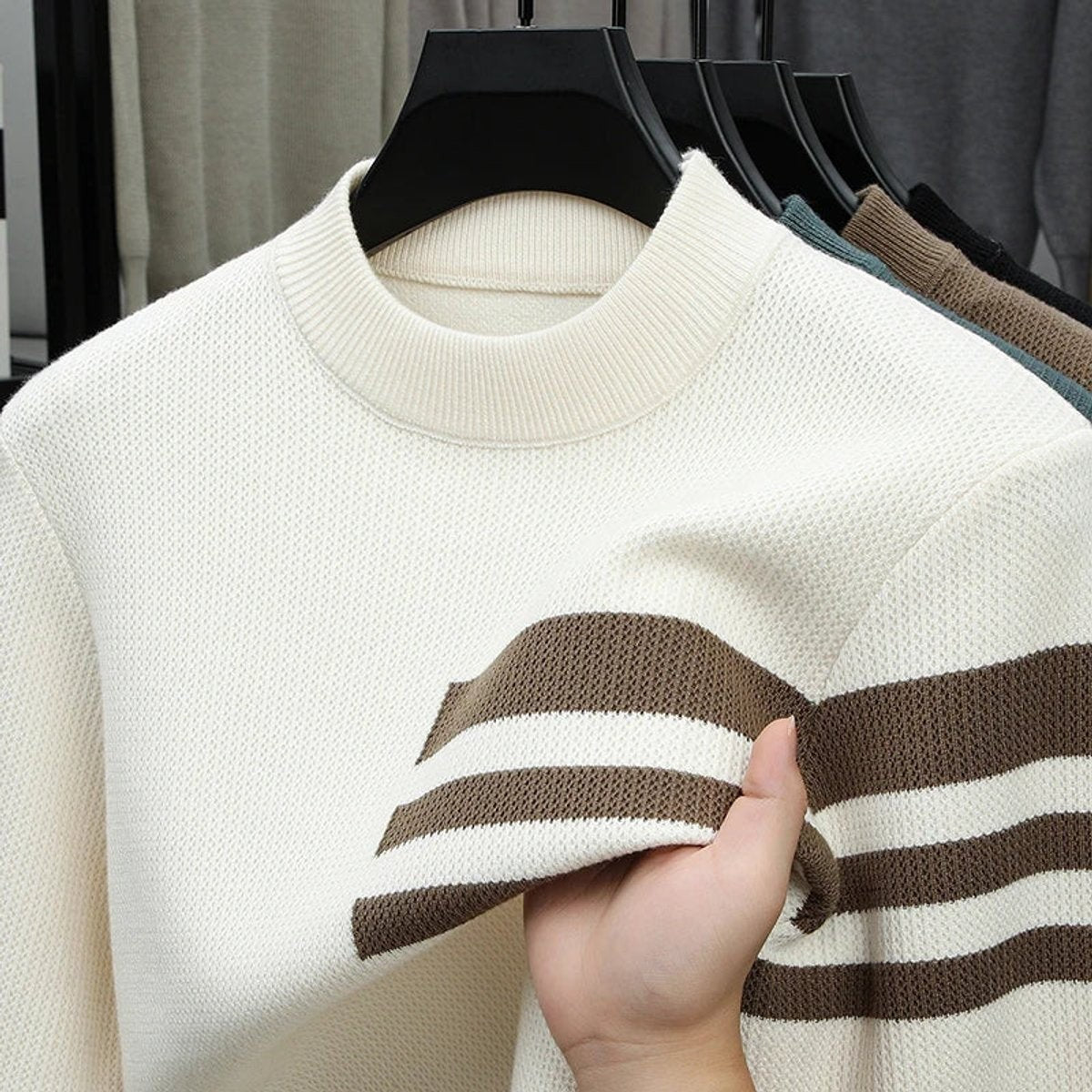 Close-up of cream striped jumper showing soft knitted textured fabric