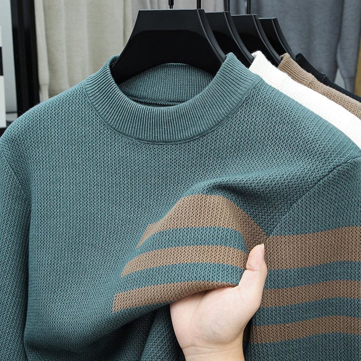 Teal striped crewneck jumper displayed on hanger with knitted texture