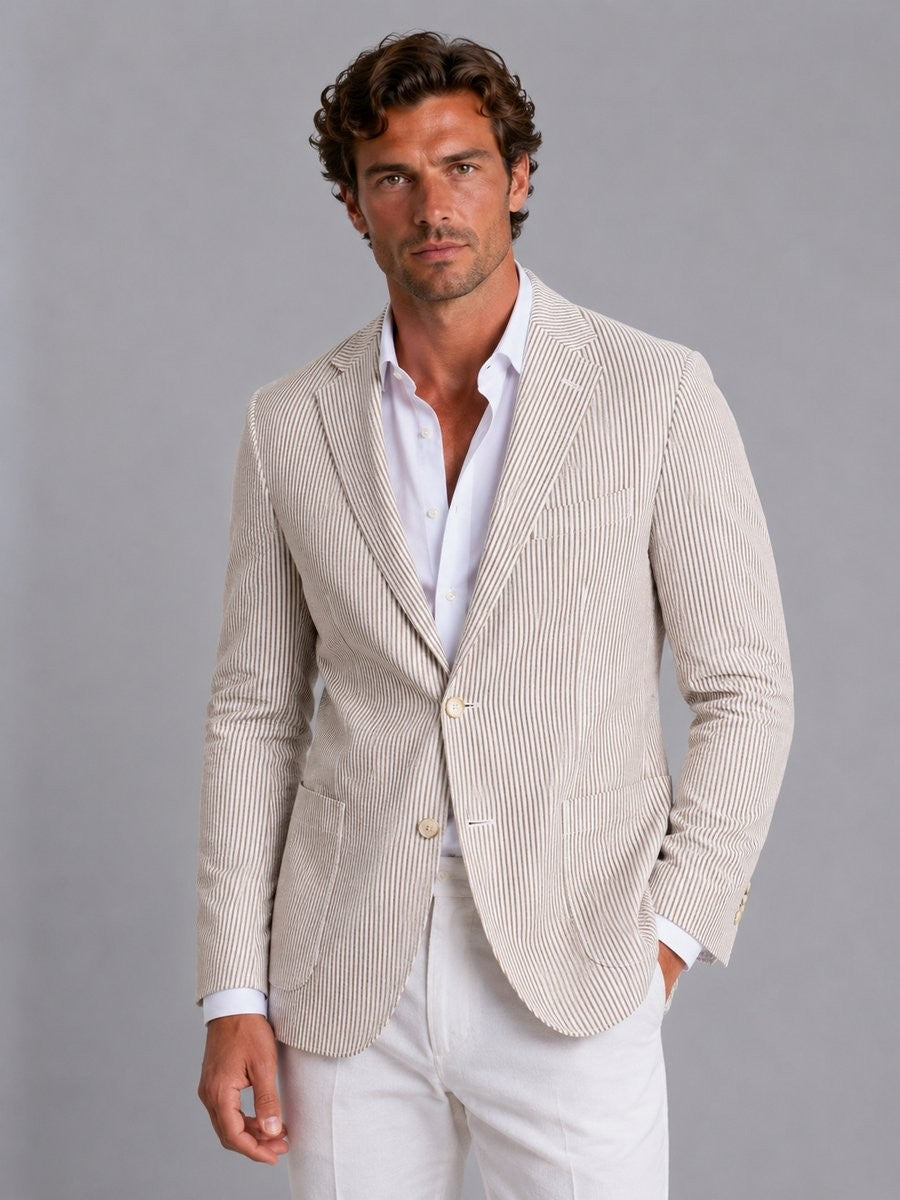 Man styling beige striped seersucker blazer with white open-collar shirt