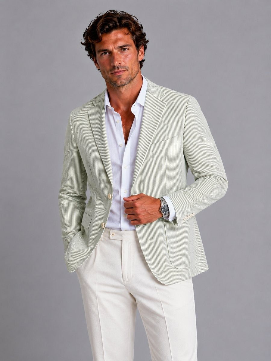 Sage green striped seersucker blazer worn with white linen trousers