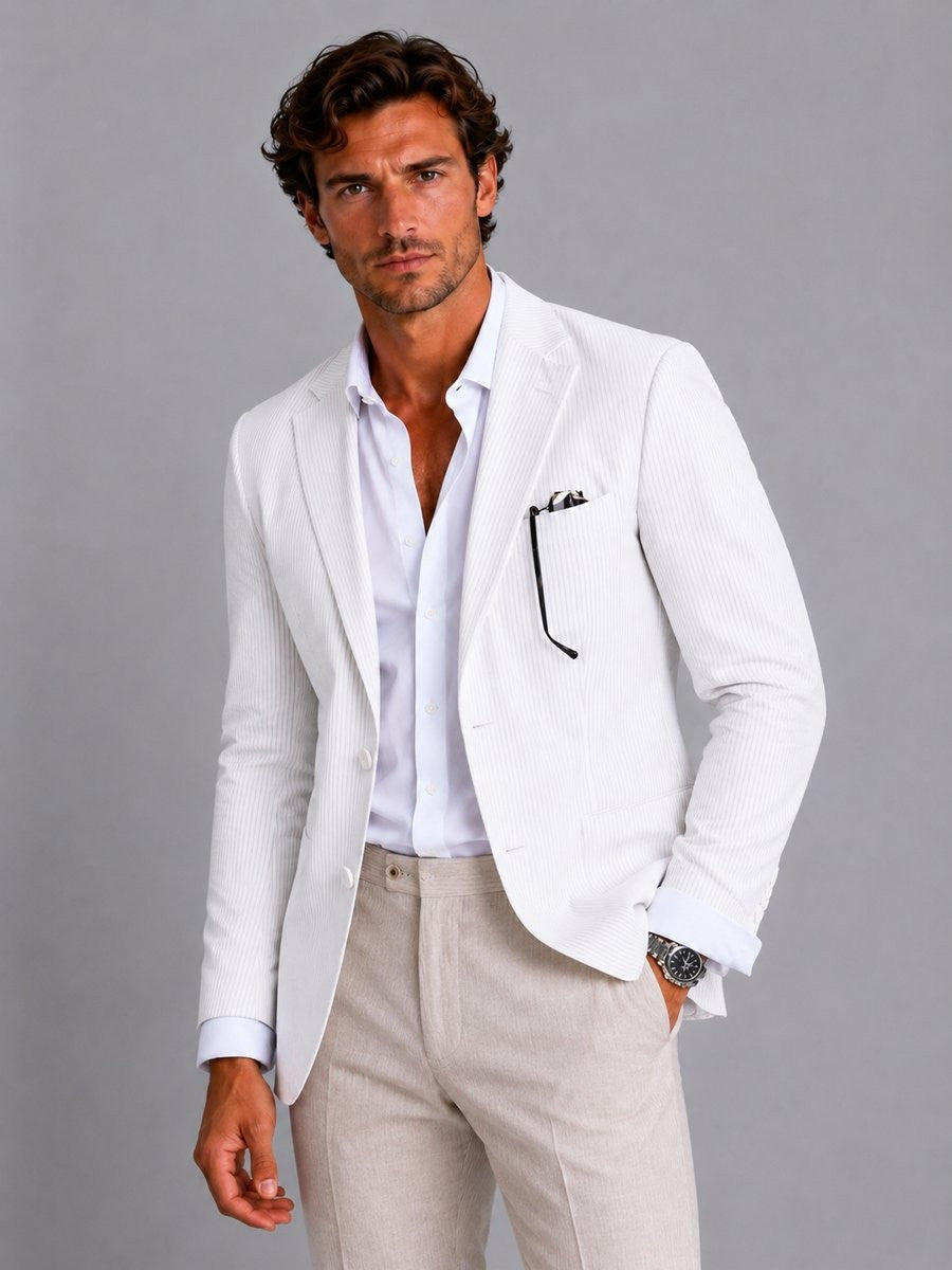 White striped seersucker blazer paired with beige trousers and sunglasses
