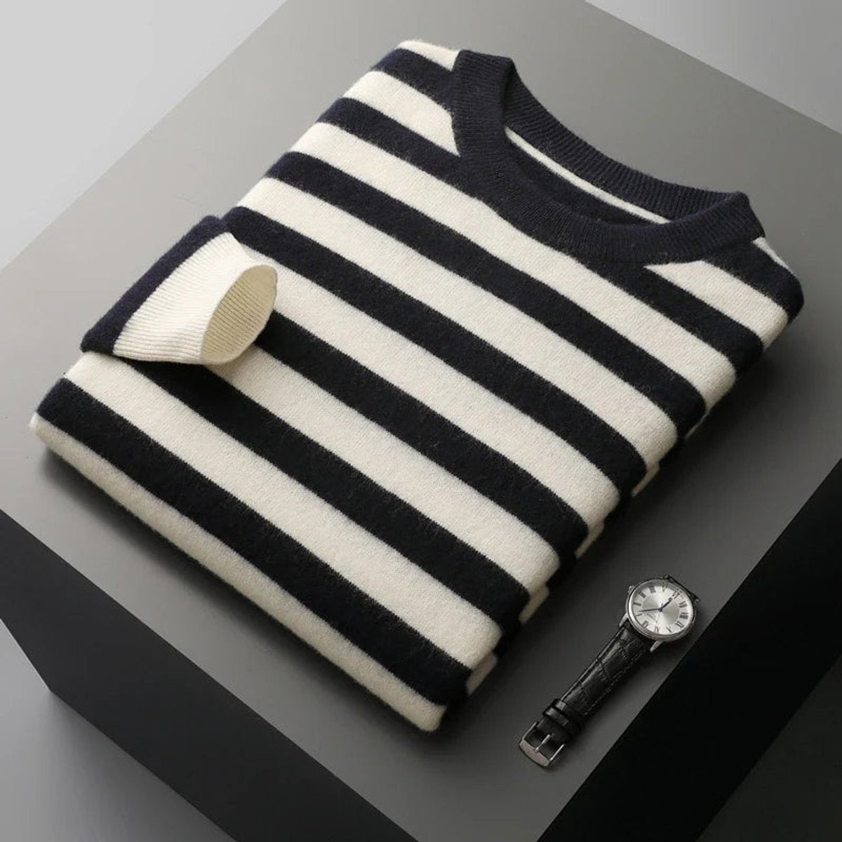 Navy and white striped jumper folded with ribbed crew collar