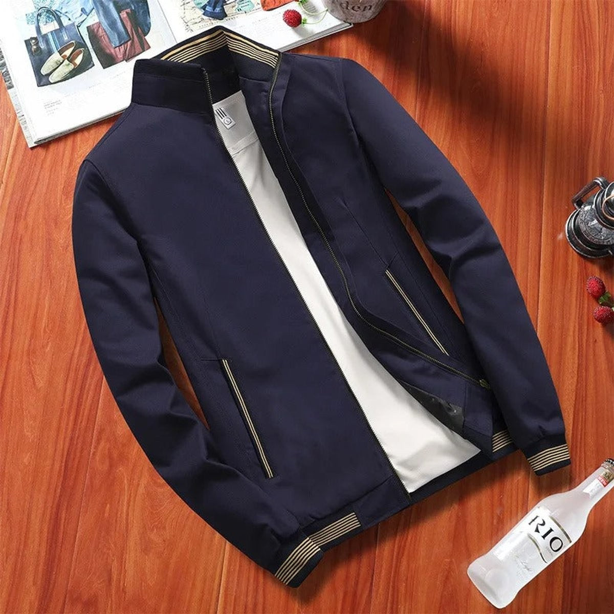 Navy bomber jacket with striped stand collar and zip-up front, laid flat
