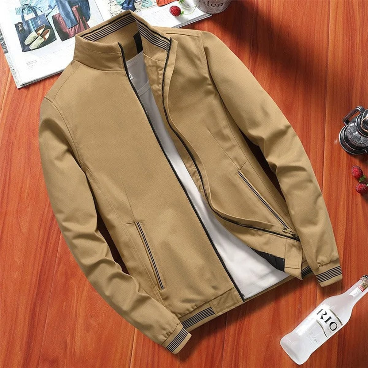 Khaki lightweight bomber jacket with striped collar and zip pockets, flat lay