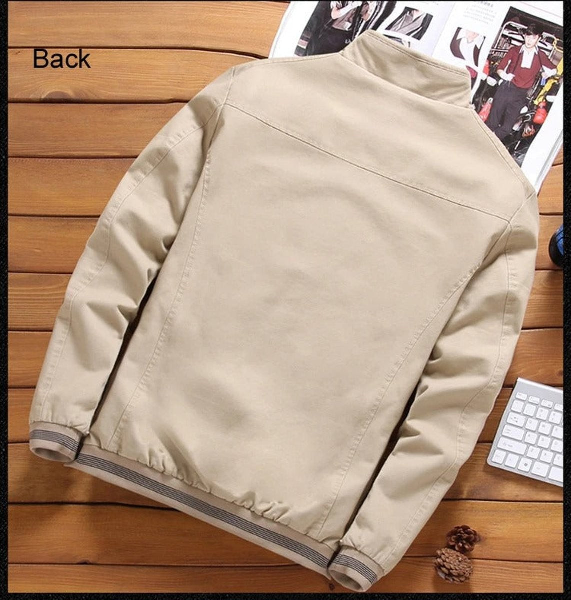 Beige bomber jacket back view showing plain panel and striped hem trim