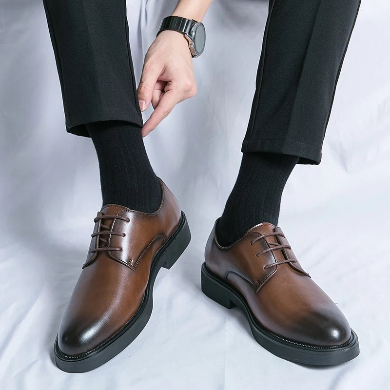 Pair of brown leather Oxford shoes fitted with wooden shoe trees