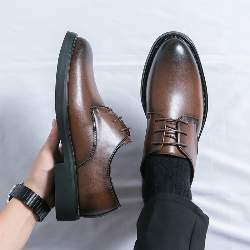 Man wearing brown leather lace-up shoes with black trousers and socks