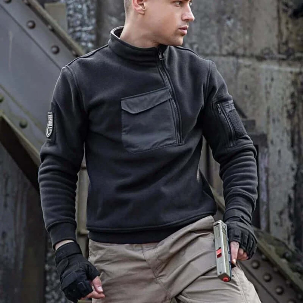 Model in black tactical quarter-zip fleece jacket with cargo trousers