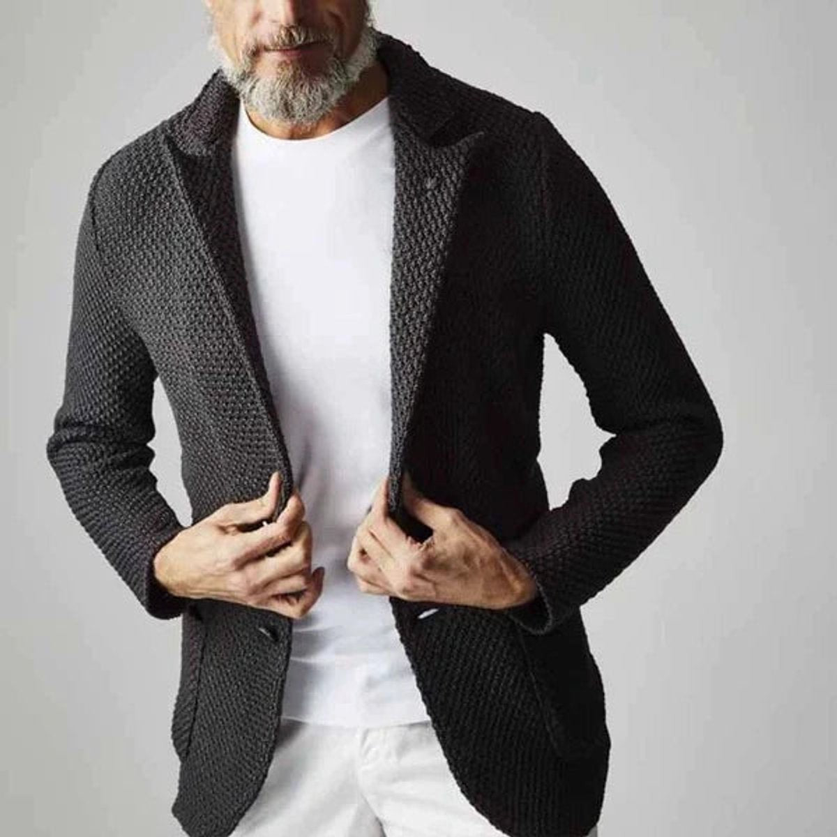 Man wearing charcoal knitted blazer with textured weave and notch lapel collar