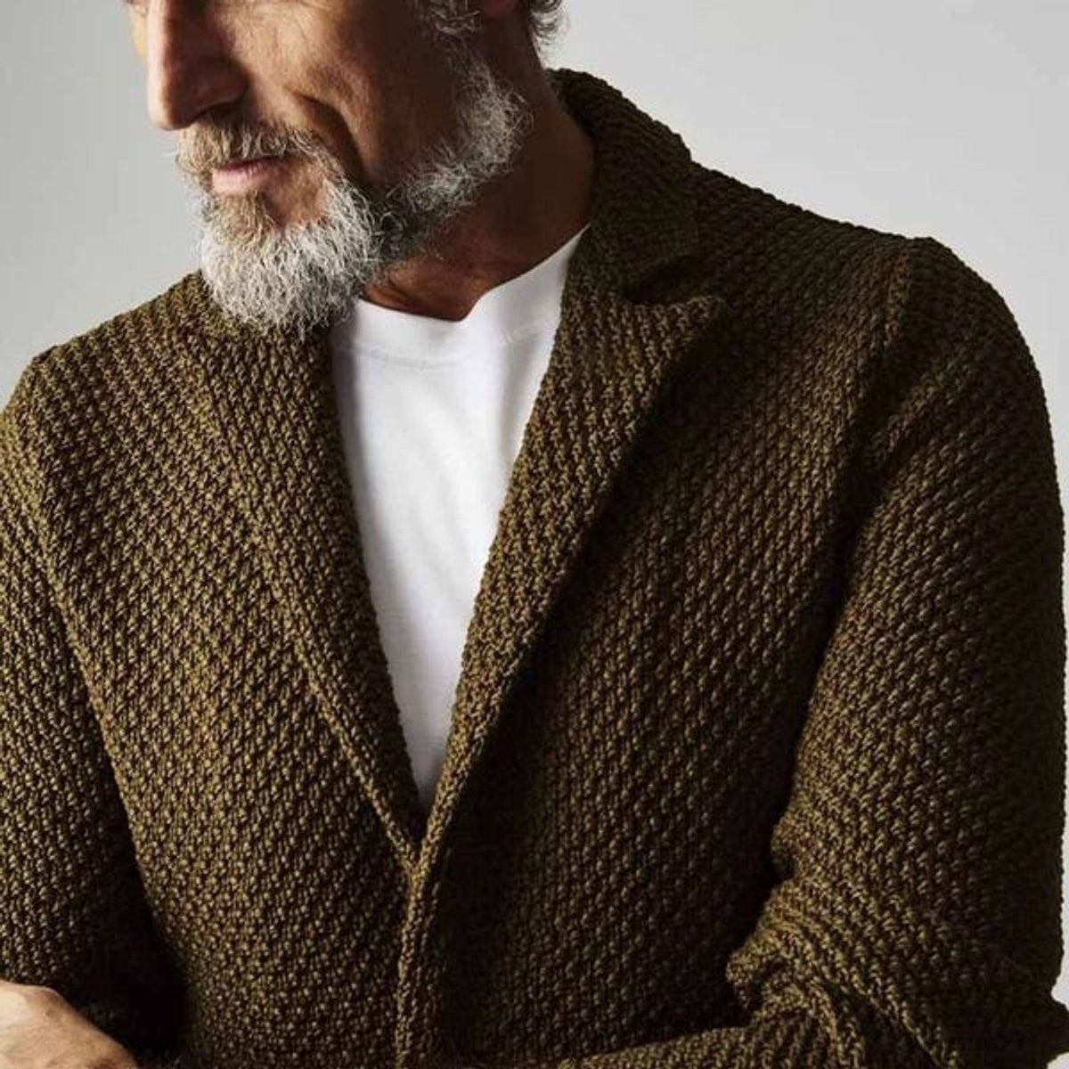 Close-up of olive green textured knit blazer with notch lapel collar detail