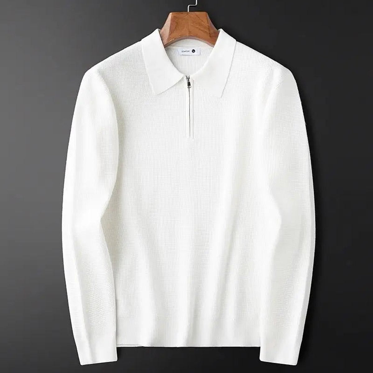 White waffle-knit quarter-zip polo jumper displayed on a wooden hanger