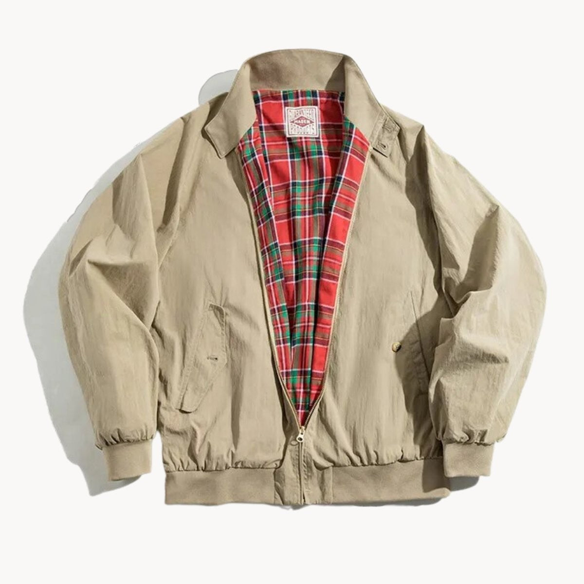 Classic khaki Harrington jacket featuring tartan-lined interior and brass zip