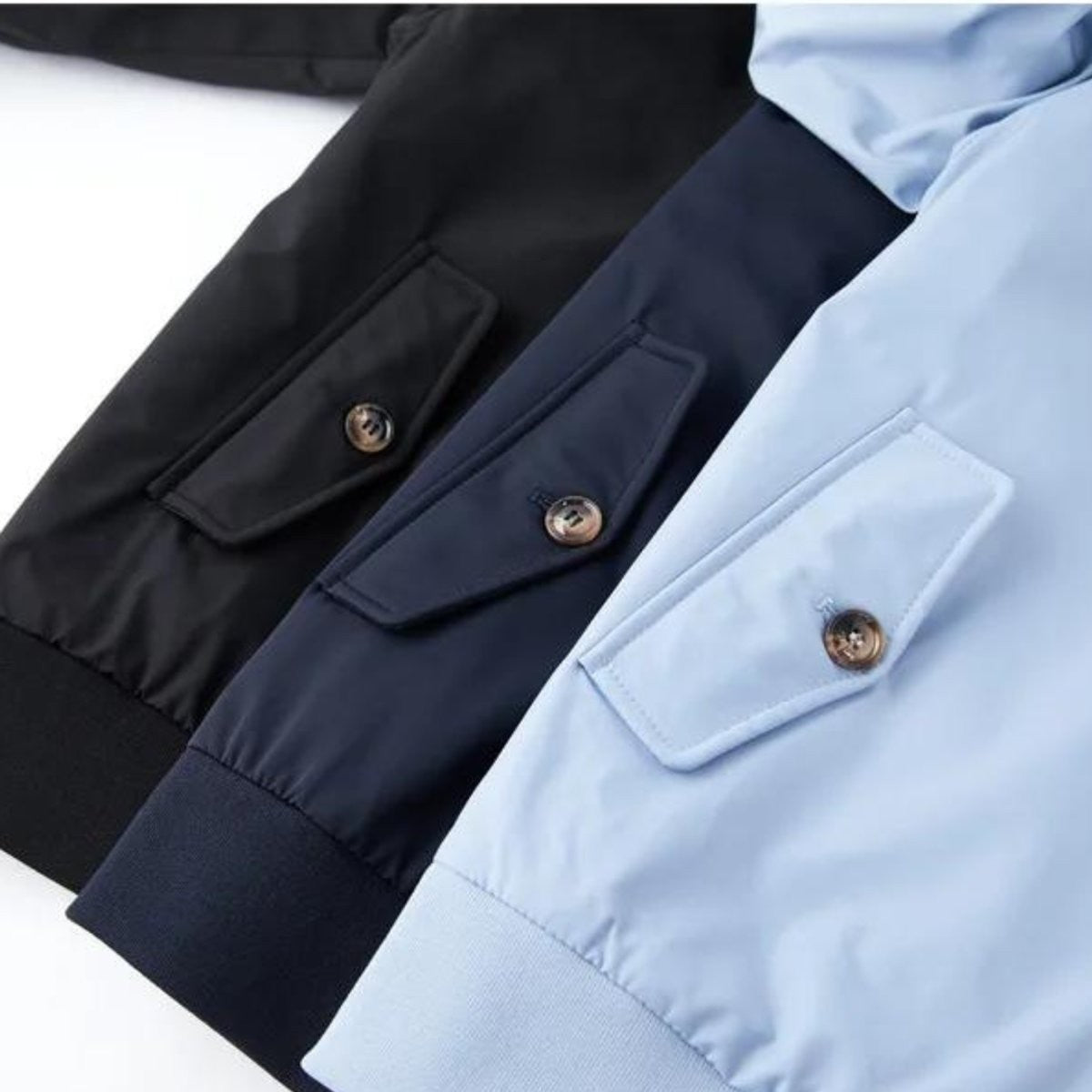 Black, navy and pale blue bomber jackets showing button-flap pockets