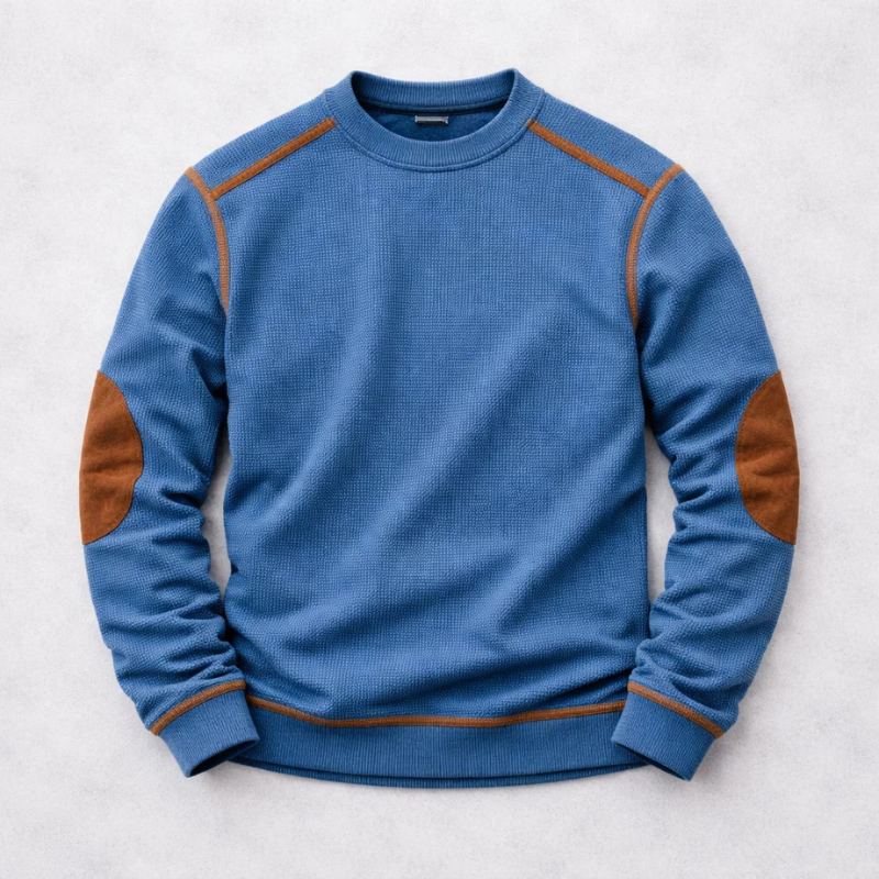 Blue waffle-knit pullover featuring tan elbow patches and raglan sleeve seams
