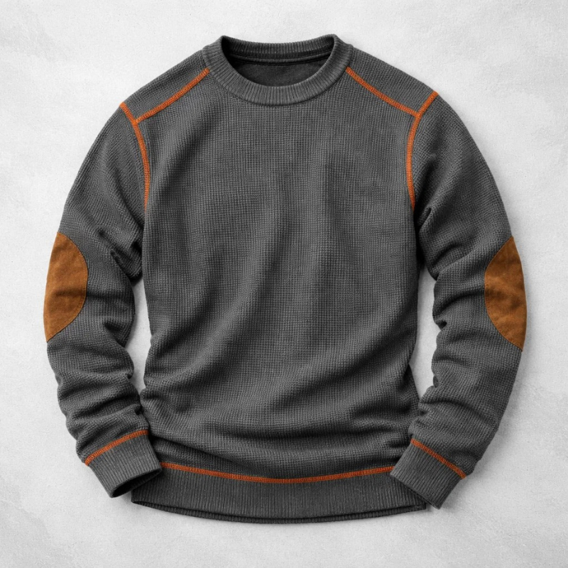 Charcoal grey knit pullover with tan elbow patches and orange contrast seams