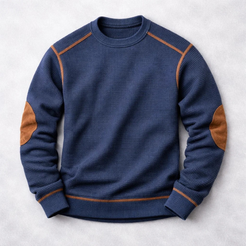 Navy waffle-knit jumper with tan suede elbow patches and ribbed hem