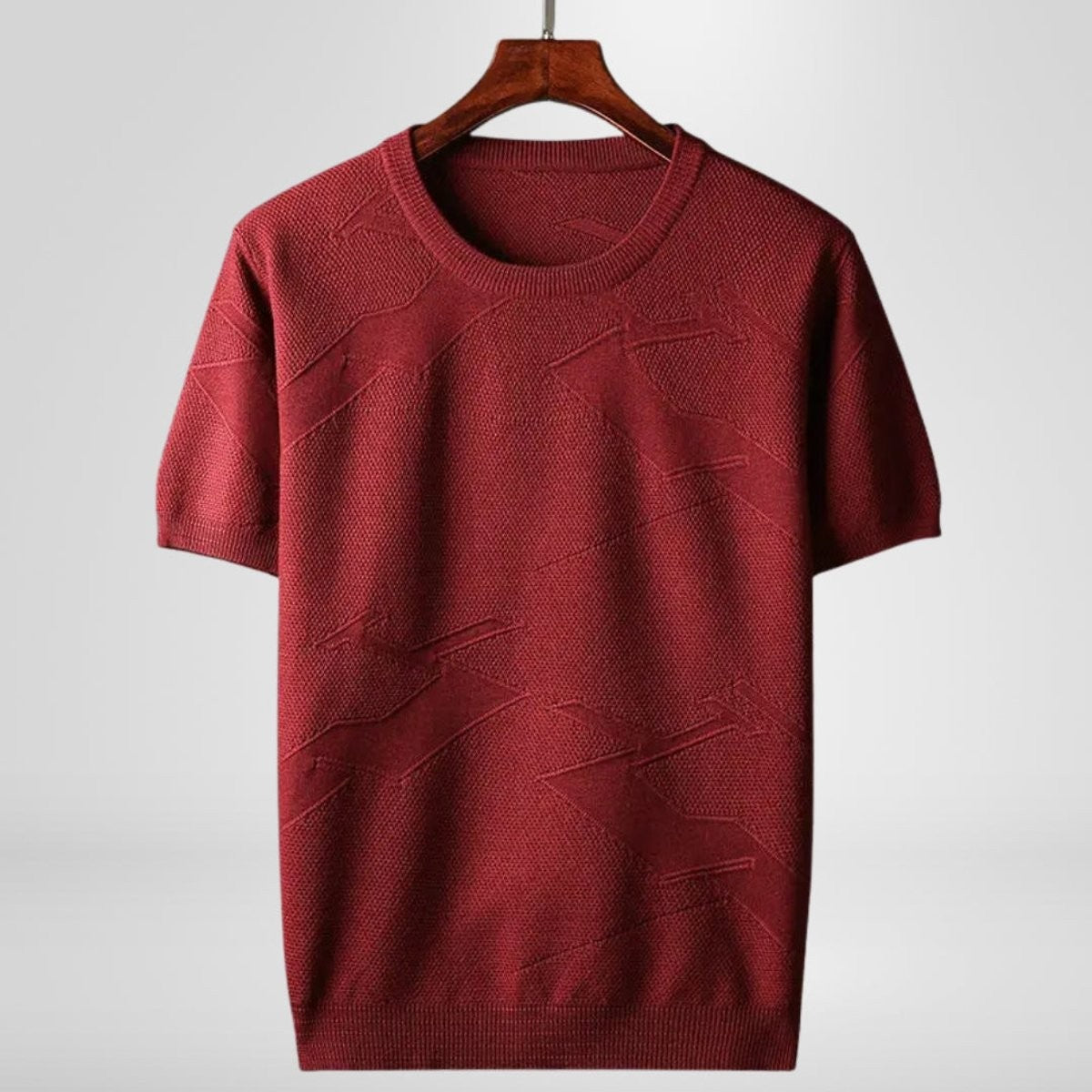Burgundy knitted crewneck jumper with textured short sleeves on hanger