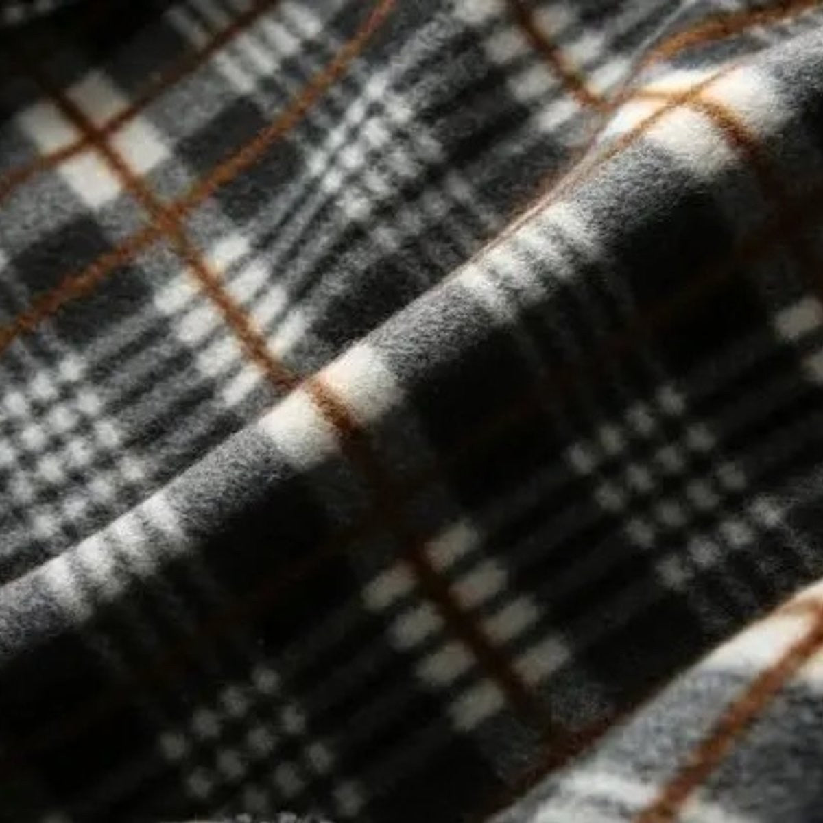 Cream knitted bomber jacket with orange tartan lining and zip