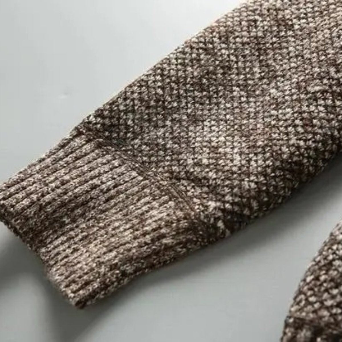 Close-up of ribbed cuff and textured knit sleeve panel