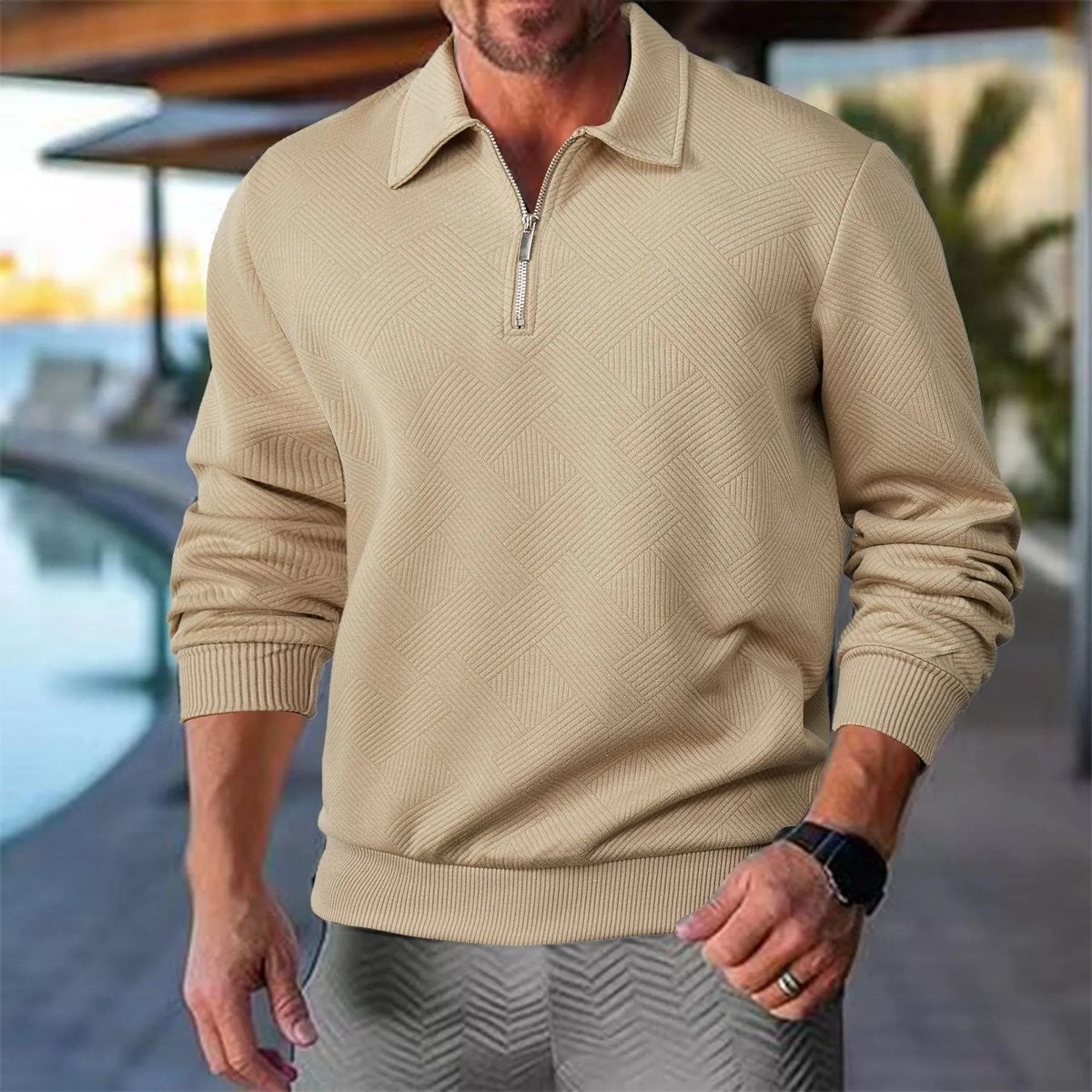 Man wearing beige quarter-zip textured polo jumper poolside