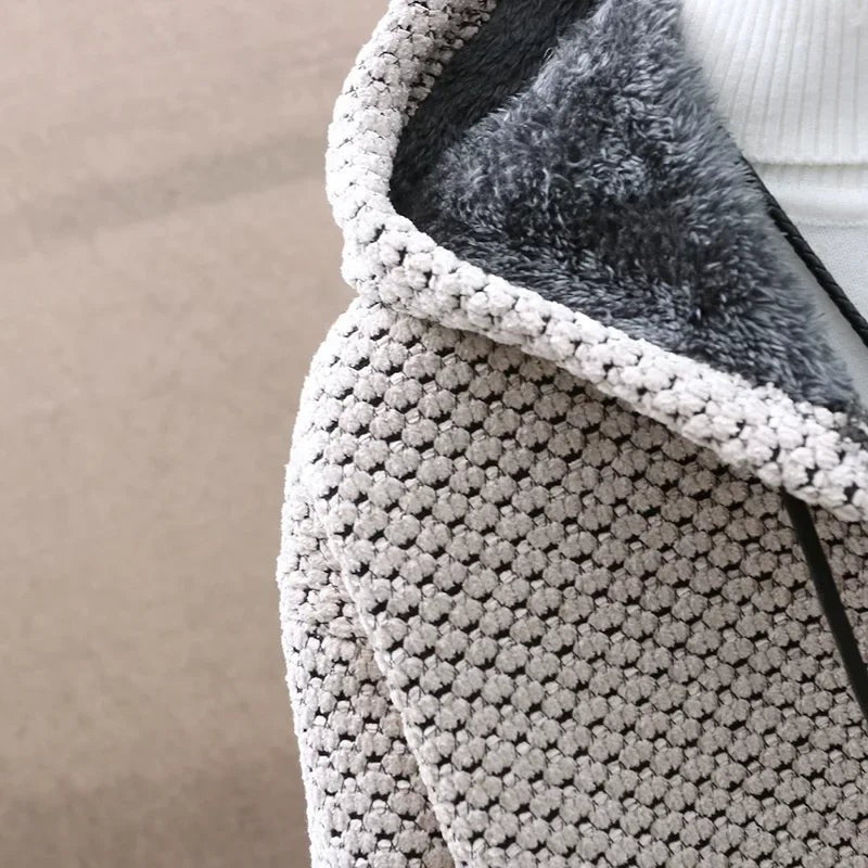 Close-up of knitted hood fabric with soft grey fleece lining