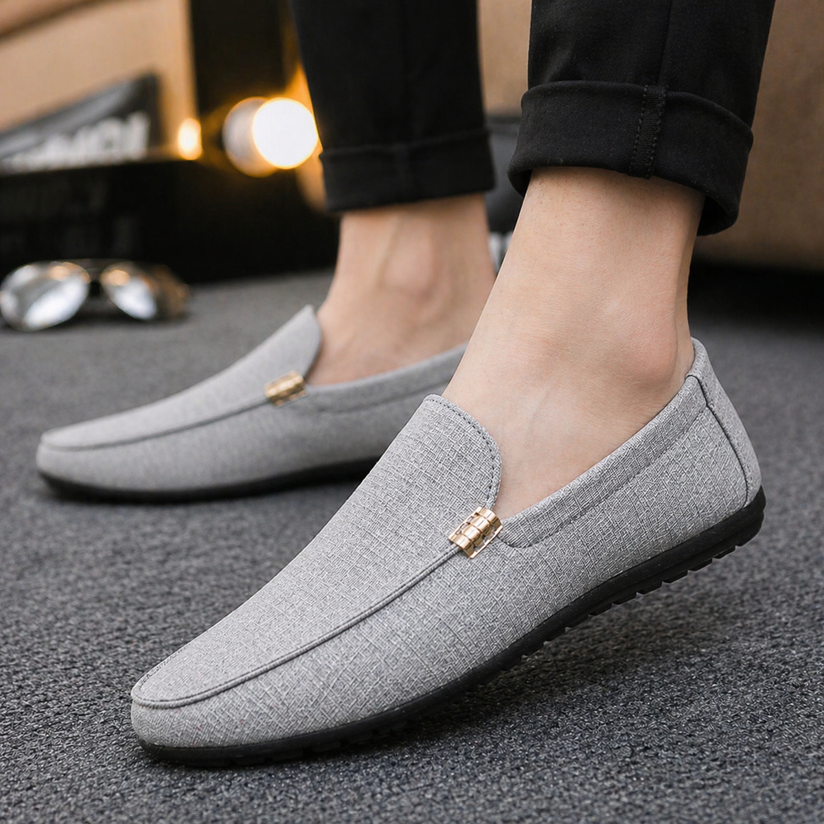 Grey textured canvas loafer worn on foot, casual outfit styling