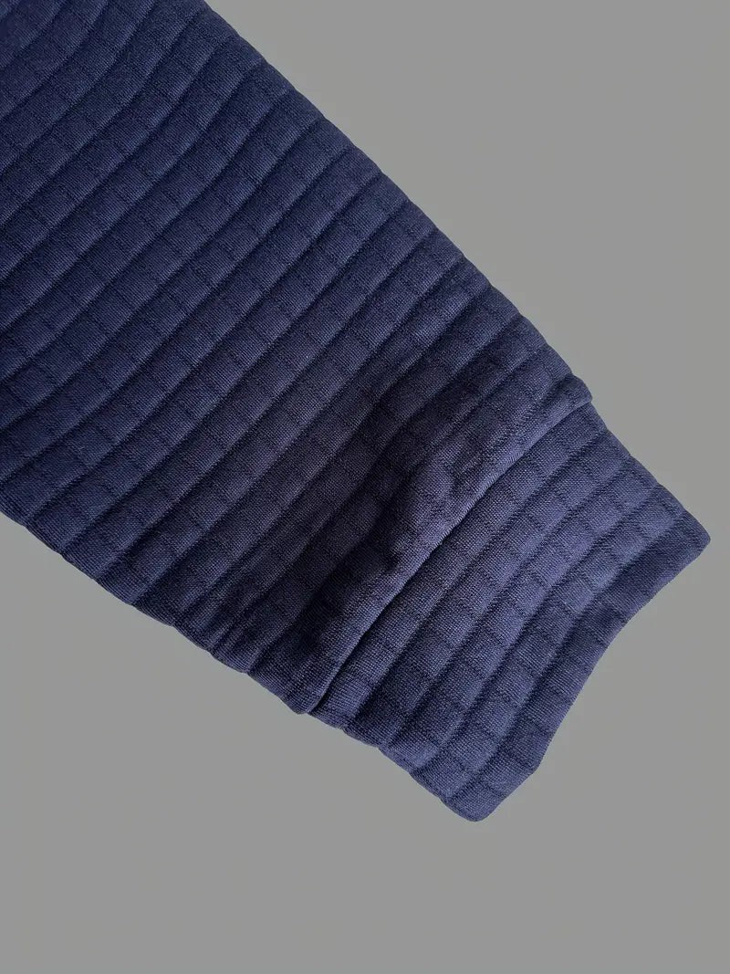 Close-up of ribbed cuff detail on navy textured long sleeve polo shirt