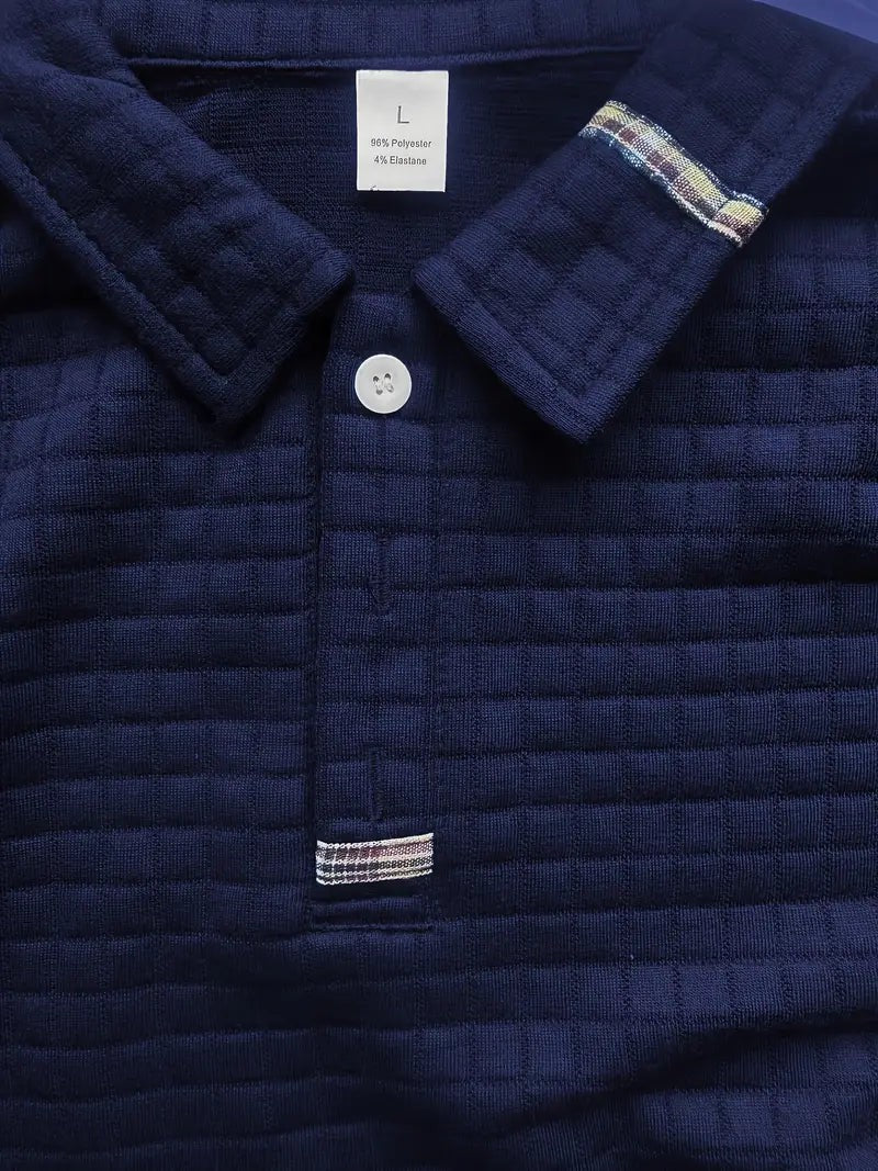 Close-up of navy polo collar showing plaid trim and button placket detail